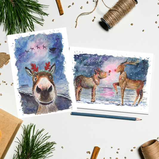 Two wholesome watercolour Christmas cards featuring illustrations of Dudley the Donkey dressed up as Rudolph on Cleethorpes Beach. Painted by Grimsby artist, Eve Leoni Smith.