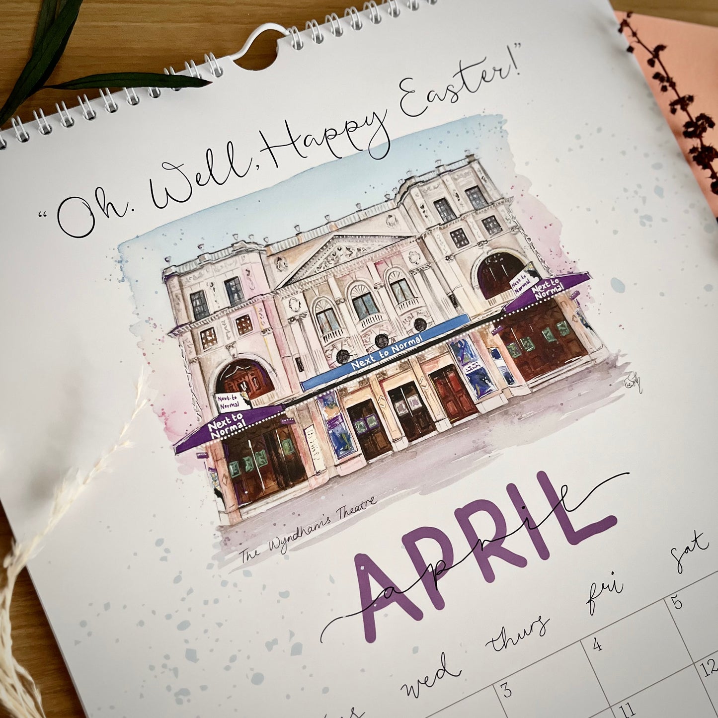 An original watercolour painting of the Wyndham’s Theatre featuring Next To Normal the musical, with a quote that says, ‘Oh. Well, Happy Easter’. Created as part of a 2025 West End calendar by Eve Leoni Art. 