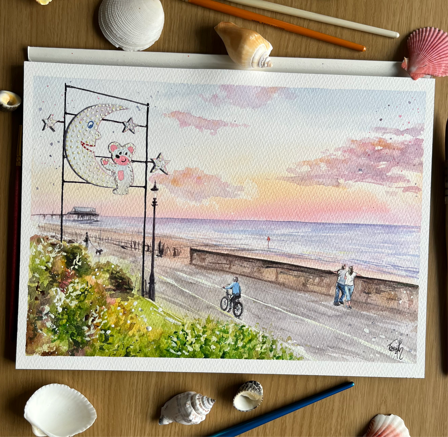 An original watercolour painting of Cleethorpes Seafront on a late summer evening, featuring the Mouse and the Moon and Cleethorpes Pier in the distance. Painted by local artist, Eve Leoni Smith. 